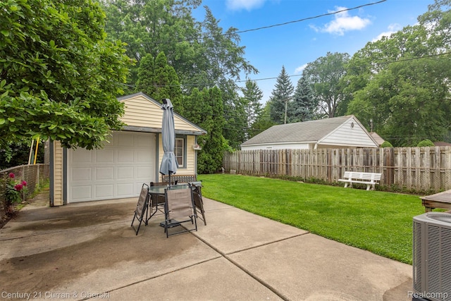 3128 Woodside Dr, Dearborn, MI 48124 - view of patio featuring an outdoor structure, central AC unit, a detached garage, and driveway