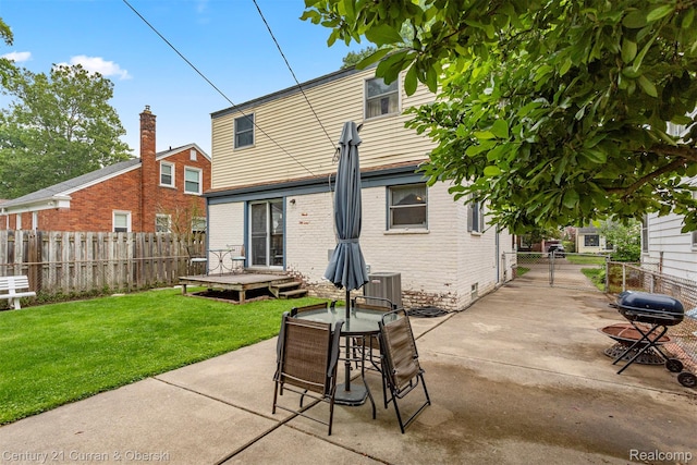 3128 Woodside Dr, Dearborn, MI 48124 - rear view of house with brick siding, a patio, central AC, and outdoor dining space