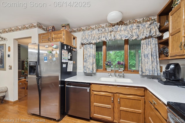14210 W Burt Rd W, Chesaning, MI 48616 - kitchen with appliances with stainless steel finishes, light countertops, light wood-style floors, and brown cabinets