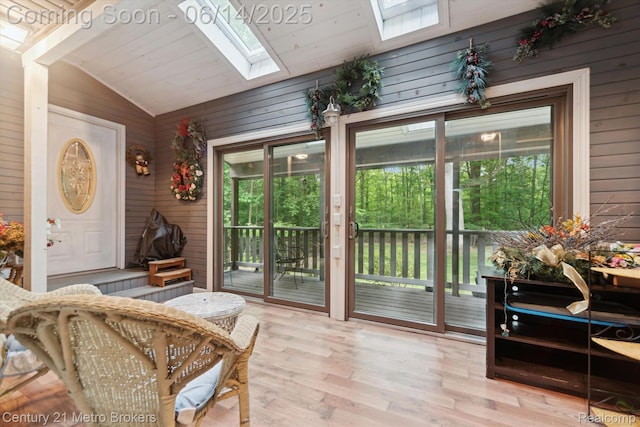14210 W Burt Rd W, Chesaning, MI 48616 - living area with a skylight, vaulted ceiling, wood walls, and wood finished floors