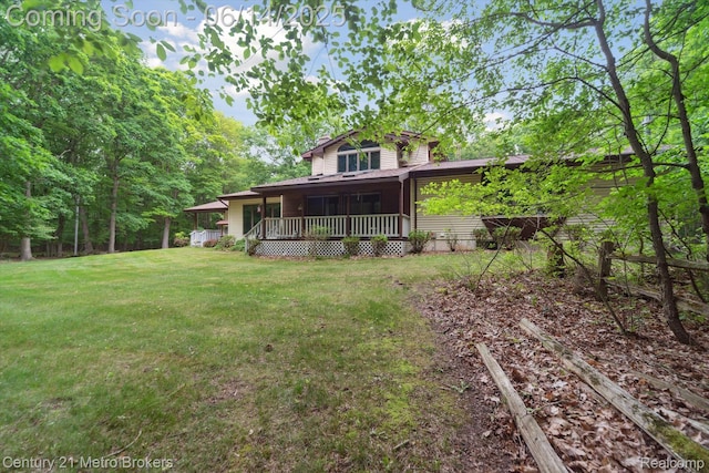 14210 W Burt Rd W, Chesaning, MI 48616 - rear view of house featuring a lawn and a porch