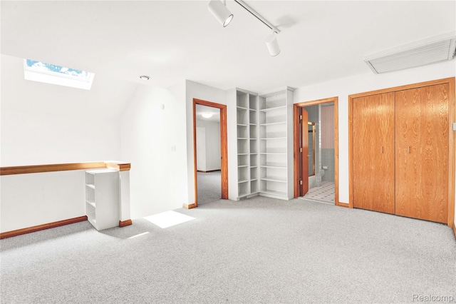 1870 Cass Lake Front Rd, Keego Harbor, MI 48320 - interior space with carpet flooring, a skylight, baseboards, ensuite bathroom, and rail lighting