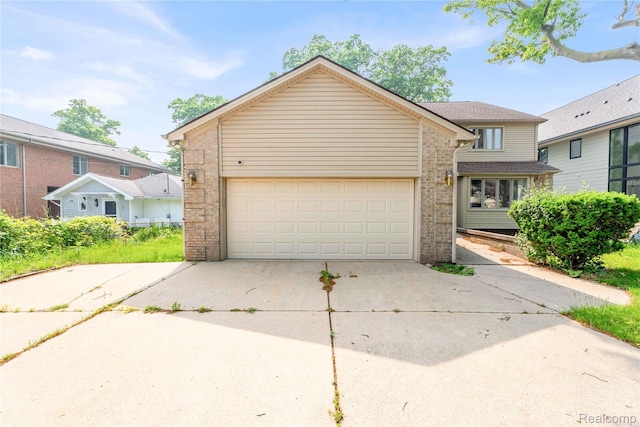 1870 Cass Lake Front Rd, Keego Harbor, MI 48320 - traditional-style home with brick siding, driveway, and a garage