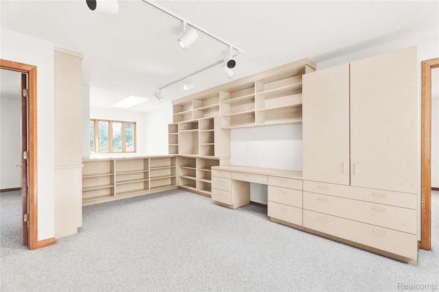 1870 Cass Lake Front Rd, Keego Harbor, MI 48320 - unfurnished office with light colored carpet, built in desk, rail lighting, and a skylight