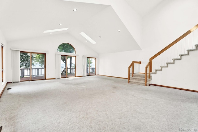 1870 Cass Lake Front Rd, Keego Harbor, MI 48320 - unfurnished living room with a skylight, healthy amount of natural light, high vaulted ceiling, stairway, and recessed lighting