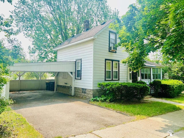 3421 3rd St, Trenton, MI 48183 - view of front of house featuring driveway, a chimney, a carport, and roof with shingles