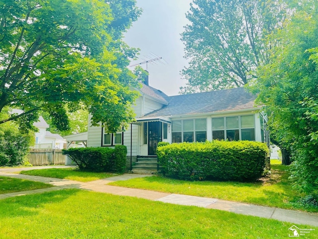 3421 3rd St, Trenton, MI 48183 - view of front facade featuring a shingled roof and a chimney