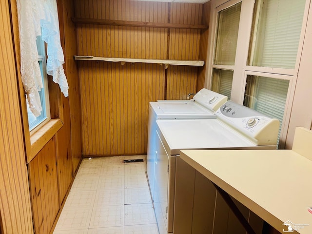 3421 3rd St, Trenton, MI 48183 - laundry area with washing machine and clothes dryer, light flooring, and wooden walls