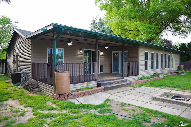 6336 Moreland Dr, Erie, MI 48133 - rear view of house featuring a ceiling fan, a lawn, covered porch, and central AC unit
