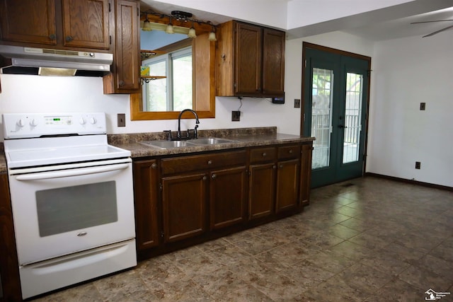 6336 Moreland Dr, Erie, MI 48133 - kitchen featuring under cabinet range hood, white range with electric stovetop, a sink, dark countertops, and baseboards