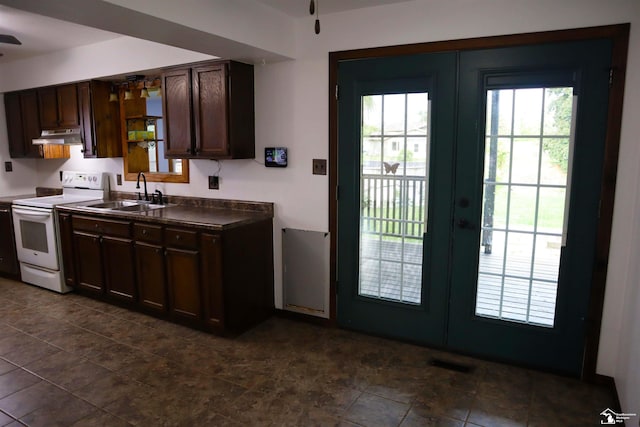 6336 Moreland Dr, Erie, MI 48133 - kitchen with white electric range oven, under cabinet range hood, french doors, and a sink