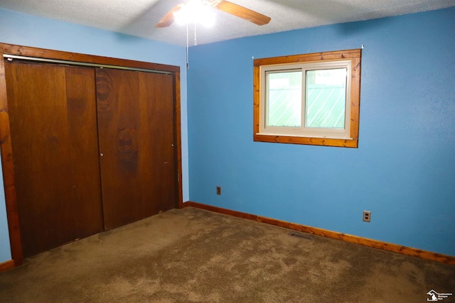 6336 Moreland Dr, Erie, MI 48133 - unfurnished bedroom featuring carpet, a closet, baseboards, ceiling fan, and a textured ceiling