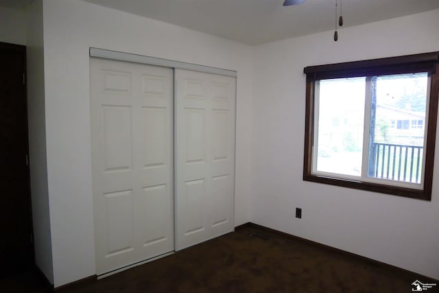 6336 Moreland Dr, Erie, MI 48133 - unfurnished bedroom with dark carpet, a closet, and baseboards