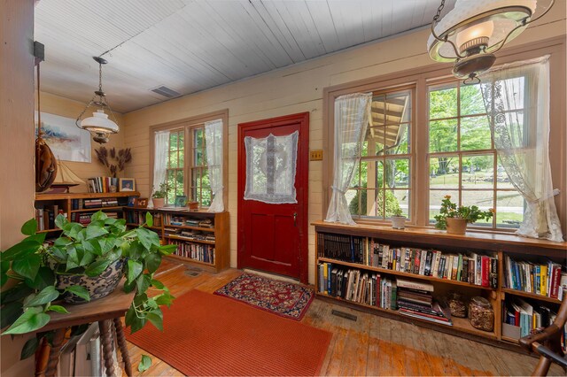8425 Parshallville Rd, Fenton, MI 48430 - entryway featuring hardwood / wood-style flooring and wooden walls