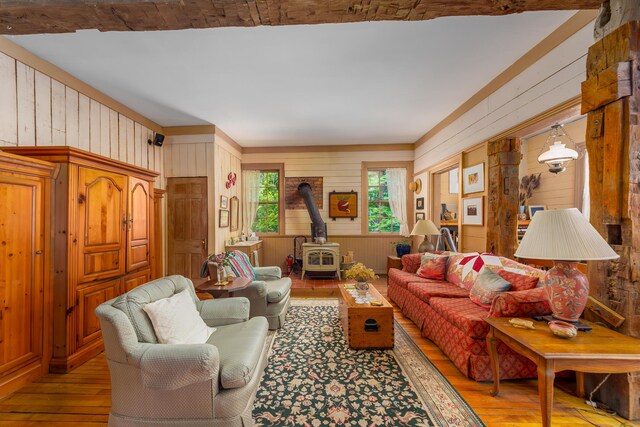 8425 Parshallville Rd, Fenton, MI 48430 - living area with a wood stove, light wood-style flooring, and wood walls