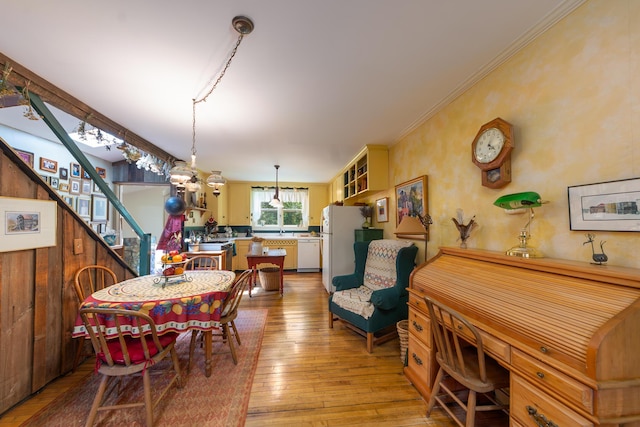 8425 Parshallville Rd, Fenton, MI 48430 - dining space featuring light wood-style floors, stairs, and crown molding