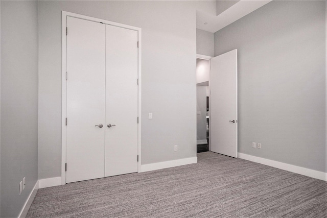 335 Bridge St NW Unit 500, Grand Rapids, MI 49504 - unfurnished bedroom featuring carpet flooring, a closet, and baseboards