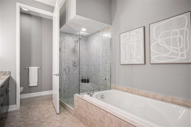 335 Bridge St NW Unit 500, Grand Rapids, MI 49504 - full bathroom with a bath, vanity, a stall shower, toilet, and tile patterned flooring