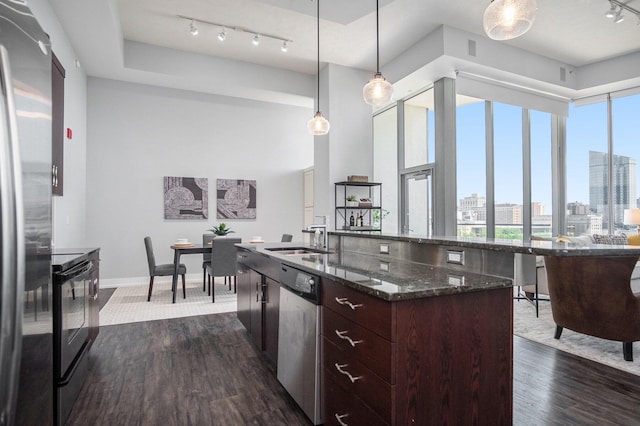 335 Bridge St NW Unit 500, Grand Rapids, MI 49504 - kitchen with appliances with stainless steel finishes, a sink, track lighting, dark wood-style floors, and dark brown cabinets