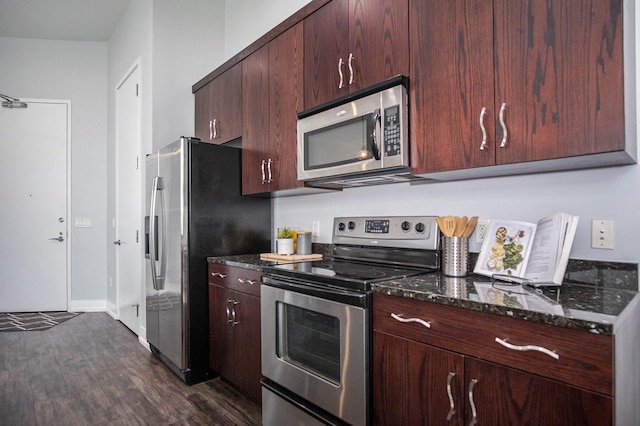 335 Bridge St NW Unit 500, Grand Rapids, MI 49504 - kitchen with stainless steel appliances, dark wood-type flooring, dark stone counters, and baseboards