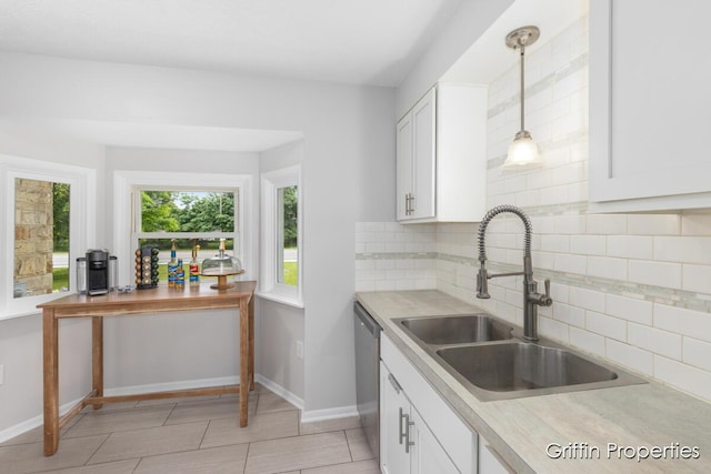 3020 Cascade Rd SE, Grand Rapids, MI 49506 - kitchen with stainless steel dishwasher, a sink, baseboards, and tasteful backsplash