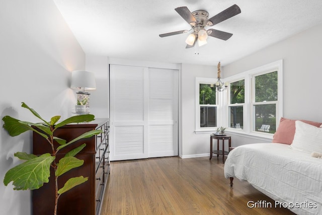 3020 Cascade Rd SE, Grand Rapids, MI 49506 - bedroom with wood finished floors, a closet, baseboards, and a ceiling fan