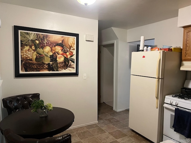 23538 Baker, Taylor, MI 48180 - kitchen featuring white appliances, under cabinet range hood, and baseboards