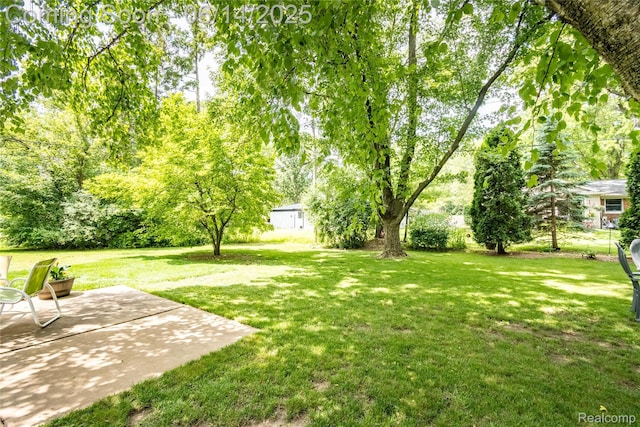28441 Westerleigh Rd, Farmington, MI 48334 - view of grassy yard with a patio