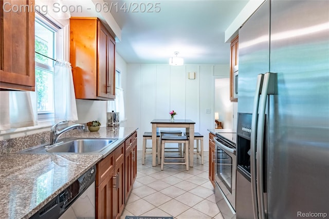 28441 Westerleigh Rd, Farmington, MI 48334 - kitchen with appliances with stainless steel finishes, brown cabinets, light tile patterned floors, and dark stone countertops