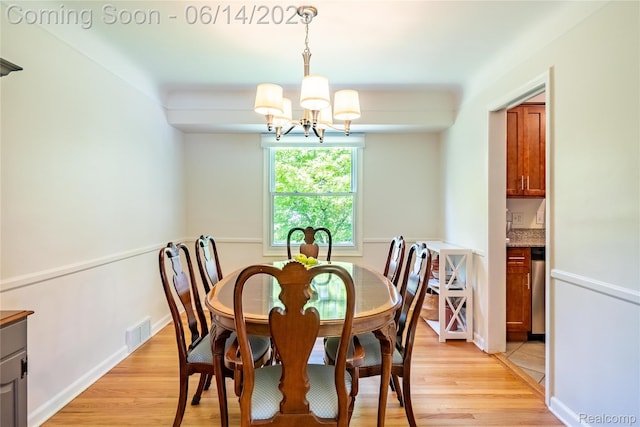 28441 Westerleigh Rd, Farmington, MI 48334 - dining room featuring a chandelier and light wood-type flooring