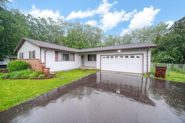 4109 Spring Arbor Rd, Jackson, MI 49201 - ranch-style house featuring a garage and driveway
