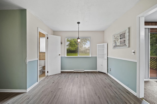 4109 Spring Arbor Rd, Jackson, MI 49201 - unfurnished dining area with wood finished floors, healthy amount of natural light, and baseboards