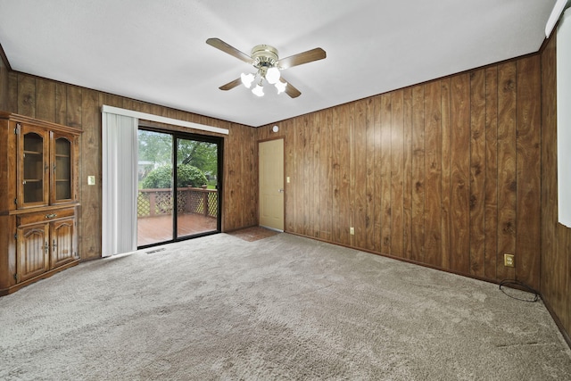 4109 Spring Arbor Rd, Jackson, MI 49201 - carpeted empty room featuring wood walls and ceiling fan