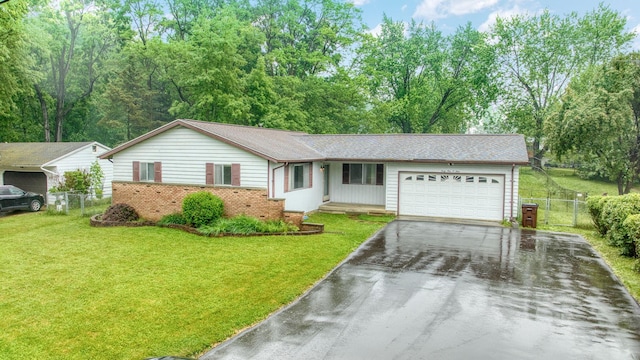4109 Spring Arbor Rd, Jackson, MI 49201 - ranch-style home with driveway, an attached garage, and brick siding