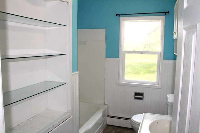 6994 E 34th Rd, Cadillac, MI 49601 - bathroom with baseboard heating, toilet, a wainscoted wall, and bathing tub / shower combination