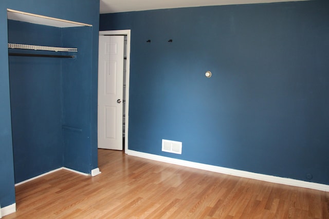 6994 E 34th Rd, Cadillac, MI 49601 - unfurnished bedroom with wood finished floors and baseboards
