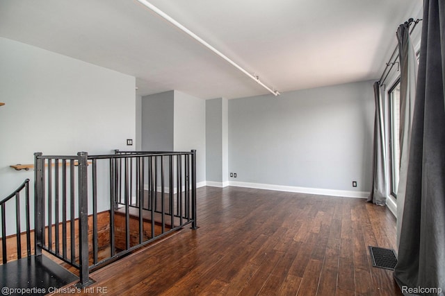 6533 E Jefferson Unit 427, Detroit, MI 48207 - empty room with dark wood-type flooring and baseboards