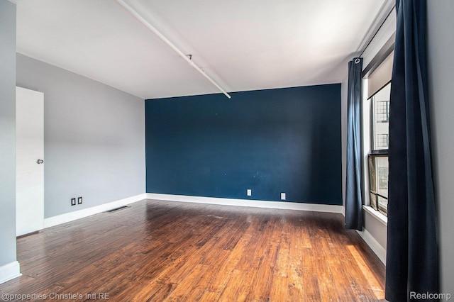 6533 E Jefferson Unit 427, Detroit, MI 48207 - empty room featuring wood finished floors and baseboards