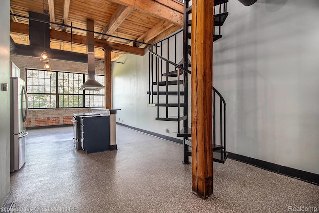 6533 E Jefferson Unit 427, Detroit, MI 48207 - interior space featuring baseboards and a wooden ceiling with exposed beams