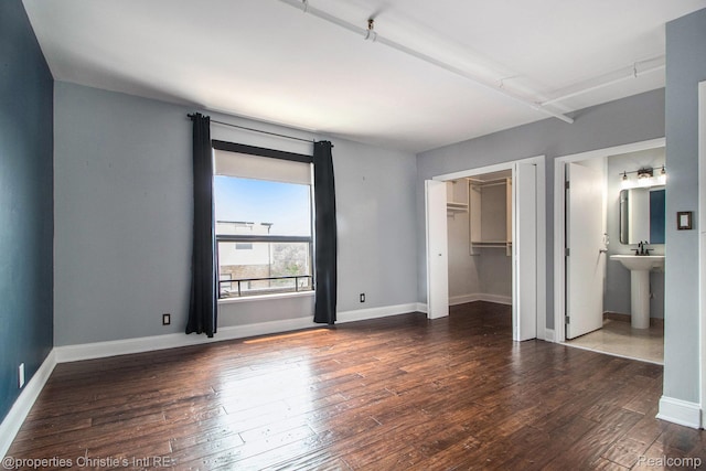 6533 E Jefferson Unit 427, Detroit, MI 48207 - unfurnished bedroom with hardwood / wood-style floors, a closet, and connected bathroom