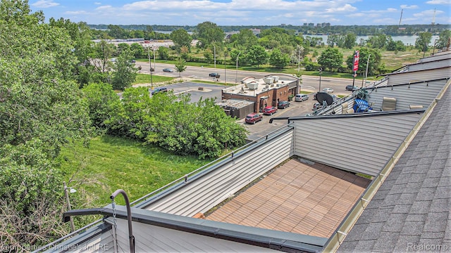 6533 E Jefferson Unit 427, Detroit, MI 48207 - balcony featuring view of wooded area