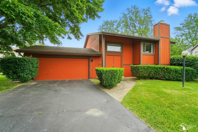 7658 Salter Ct, Temperance, MI 48182 - view of front of house with a chimney, a garage, asphalt driveway, and a front yard