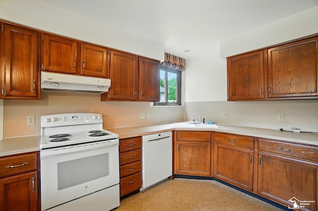 7658 Salter Ct, Temperance, MI 48182 - kitchen with white appliances, under cabinet range hood, light countertops, and brown cabinetry