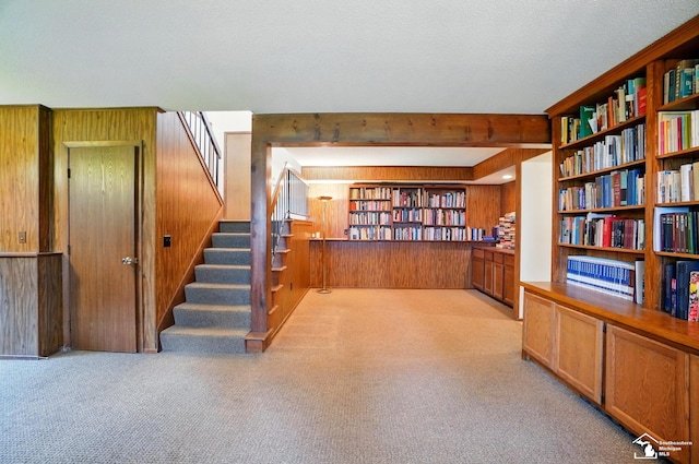 7658 Salter Ct, Temperance, MI 48182 - interior space featuring wood walls, carpet flooring, stairs, and wall of books