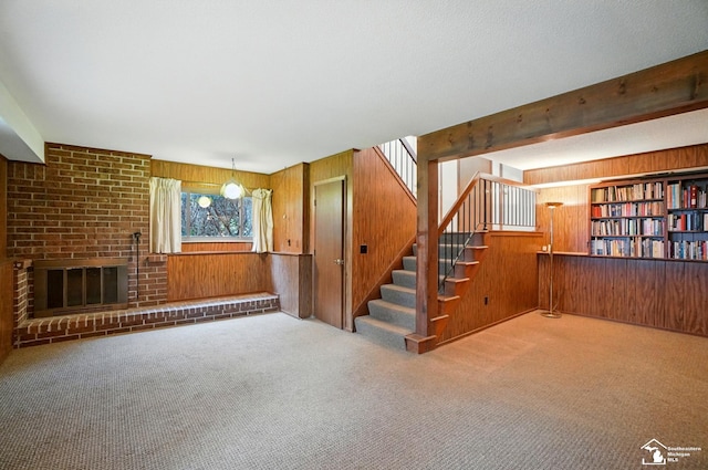 7658 Salter Ct, Temperance, MI 48182 - unfurnished living room with wood walls, carpet floors, and stairway
