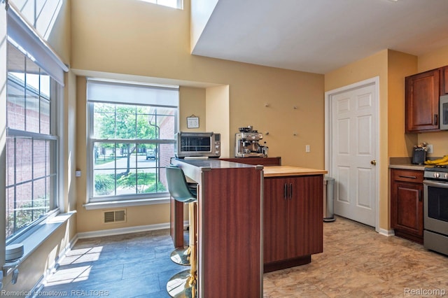 400 Cherry Grove Rd, Canton, MI 48188 - kitchen with stainless steel appliances, a kitchen island, and light countertops