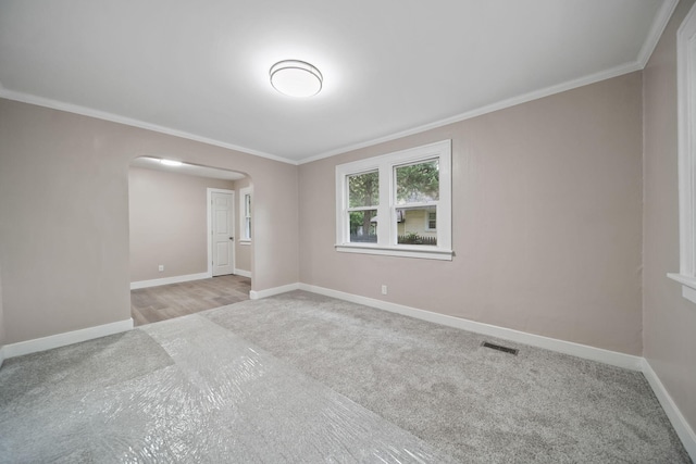 164 Cross St, Michigan Center, MI 49254 - carpeted spare room featuring arched walkways, baseboards, and ornamental molding