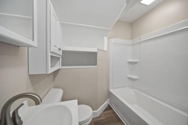 164 Cross St, Michigan Center, MI 49254 - bathroom with toilet, a sink, wood finished floors, and shower / bathtub combination