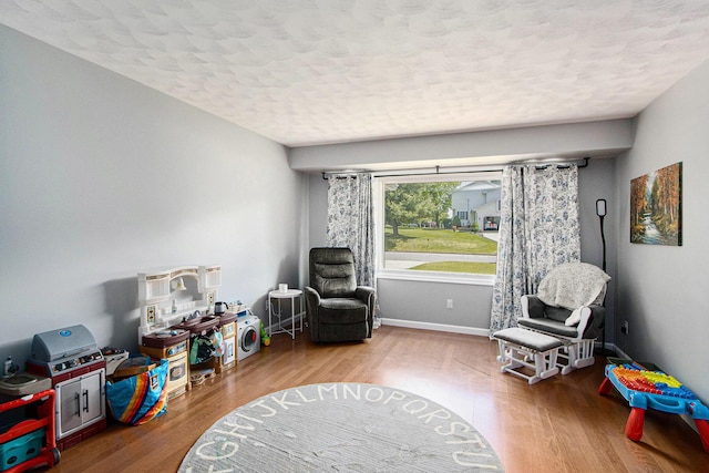 2030 Surry, Schoolcraft, MI 49087 - rec room featuring a textured ceiling, wood finished floors, and baseboards