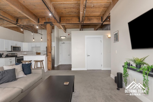 940 Monroe Ave NW Unit 335, Grand Rapids, MI 49503 - living room with wooden ceiling with exposed beams, light colored carpet, and baseboards